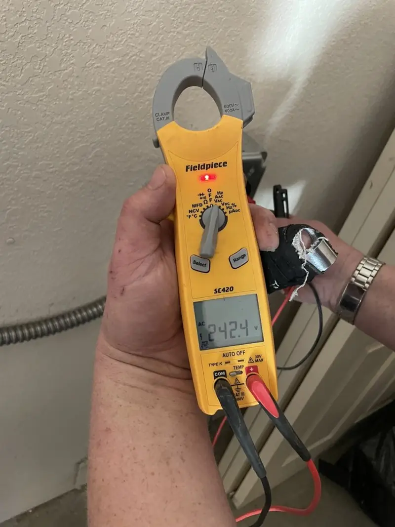 Voltage testing with clamp meter during Whole House Surge Protector in South Milwaukee